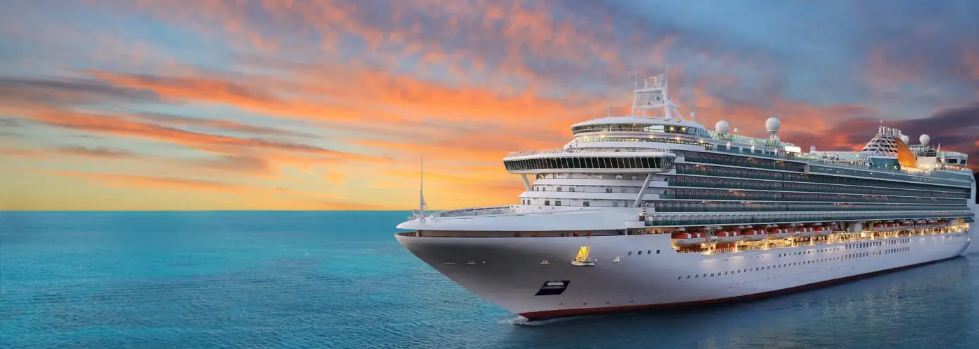 Cruise ship sailing at sunset